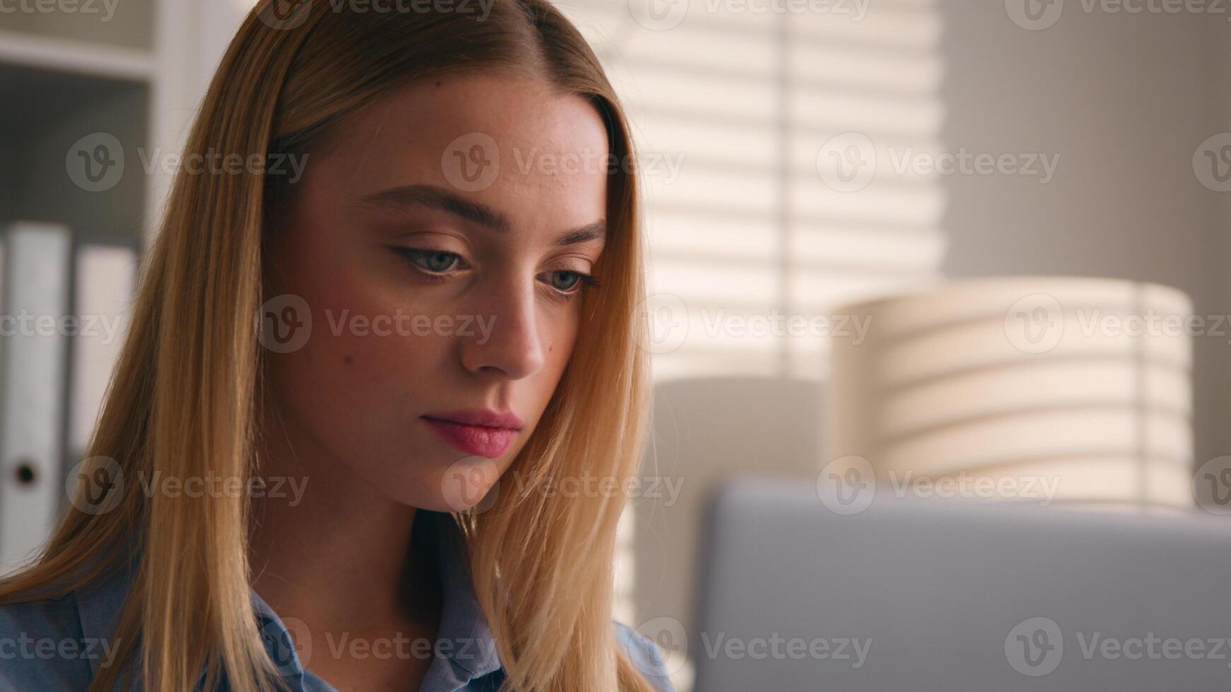 Concentrated Caucasian student girl studying in home office with laptop dissatisfied confused online task business woman businesswoman work with computer listen music dancing with head call photo