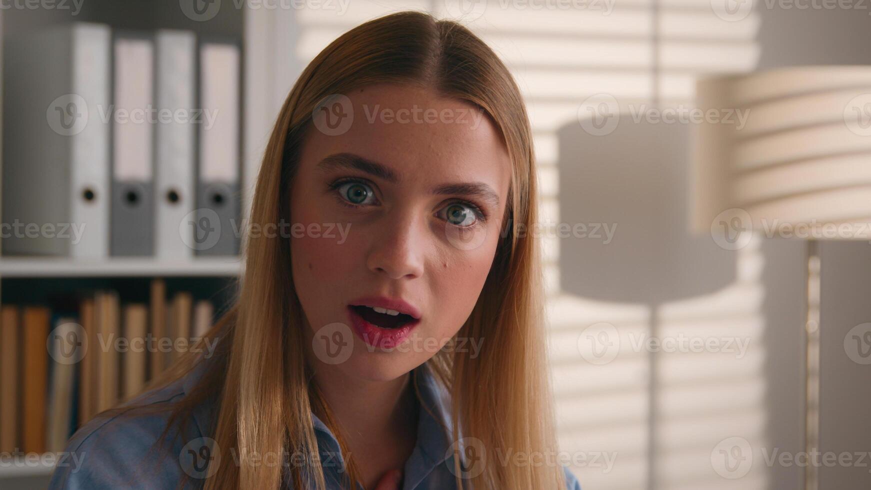 Shocked female face big eyes open mouth portrait amazed astonished stunned wonder astonish manager lady student girl in library surprised Caucasian woman unexpected news shock businesswoman in office photo