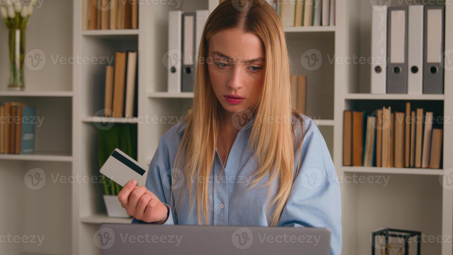 Confused puzzled client female hold bank credit card try to pay online annoyed with payment rejection problem wrong password. Worried girl woman trouble virtual money unsuccessful shopping with laptop photo