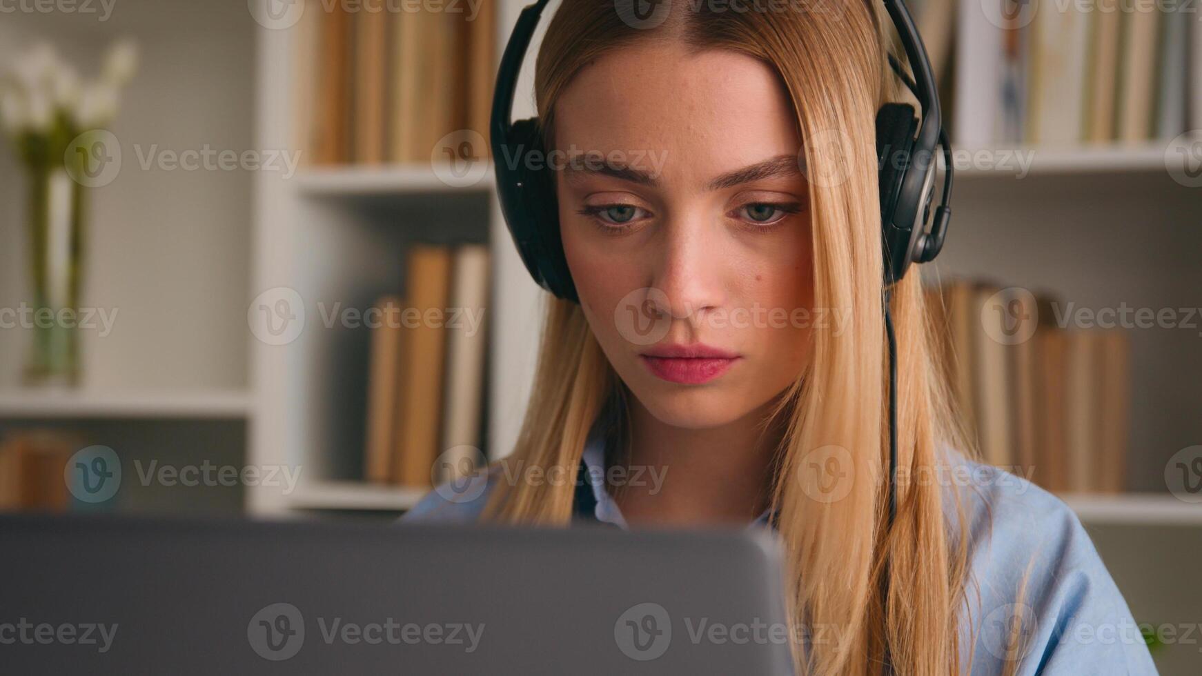Serious frowning business woman girl businesswoman remote worker distant manager in headphones communicating by call conference listen discuss virtual negotiate with laptop online office chat photo