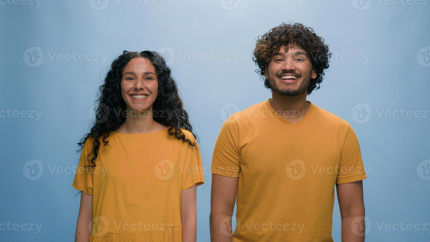 Studio portrait Indian family Arabian happy smiling couple Hispanic laughing man woman smile laugh carefree cheerful positive looking at camera fun married wife husband models together blue background photo