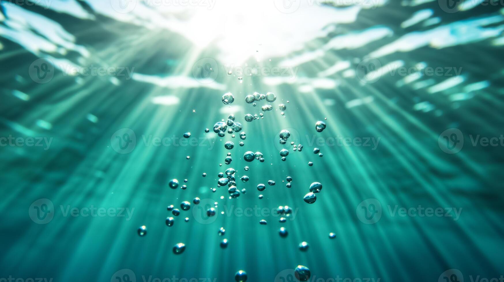 Magnified view of underwater bubbles rising towards the surface with light rays penetrating photo