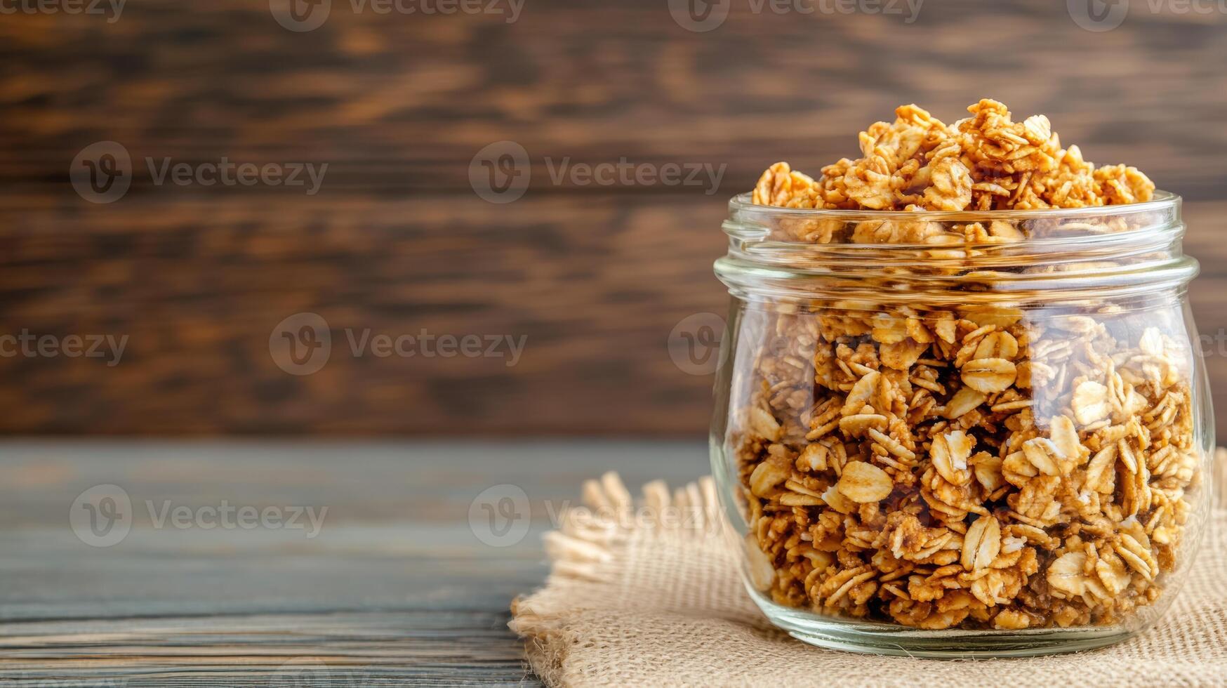 Honey flavored granola in a glass jar with a burlap sack market stall background rustic feel photo