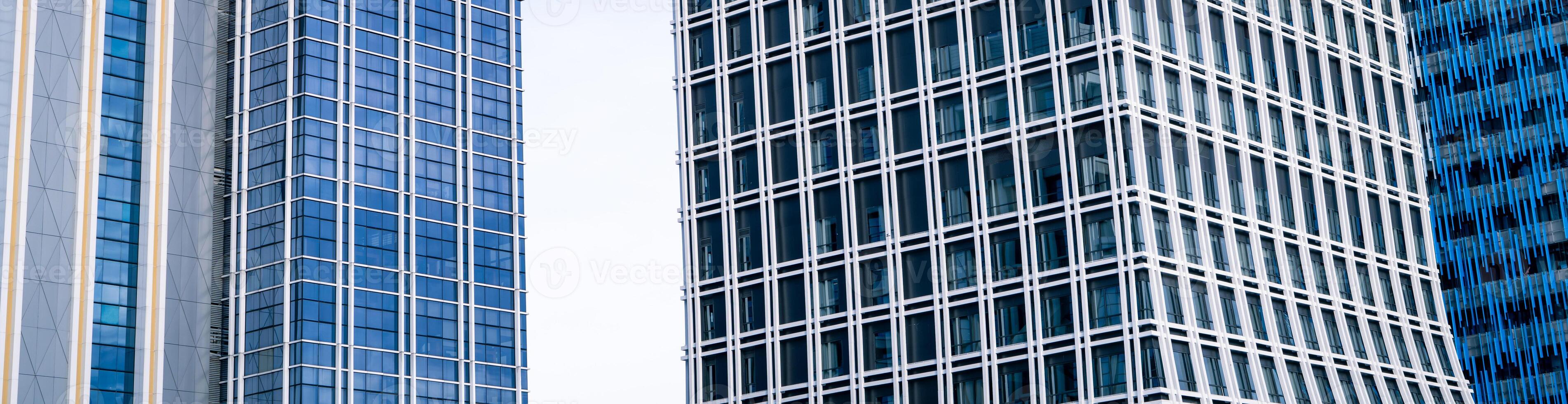 Skyscraper glass building of corporate headquarters in the downtown business area. Towering facade and windows embodying sleek, modern office environment. Financial institution. Modern architecture. photo