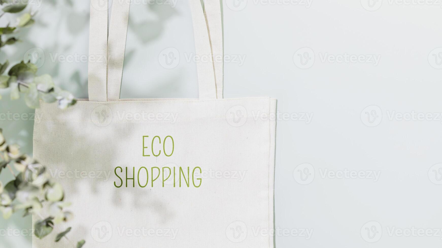 Shopping bag with text Eco shopping on blue background with copy space photo