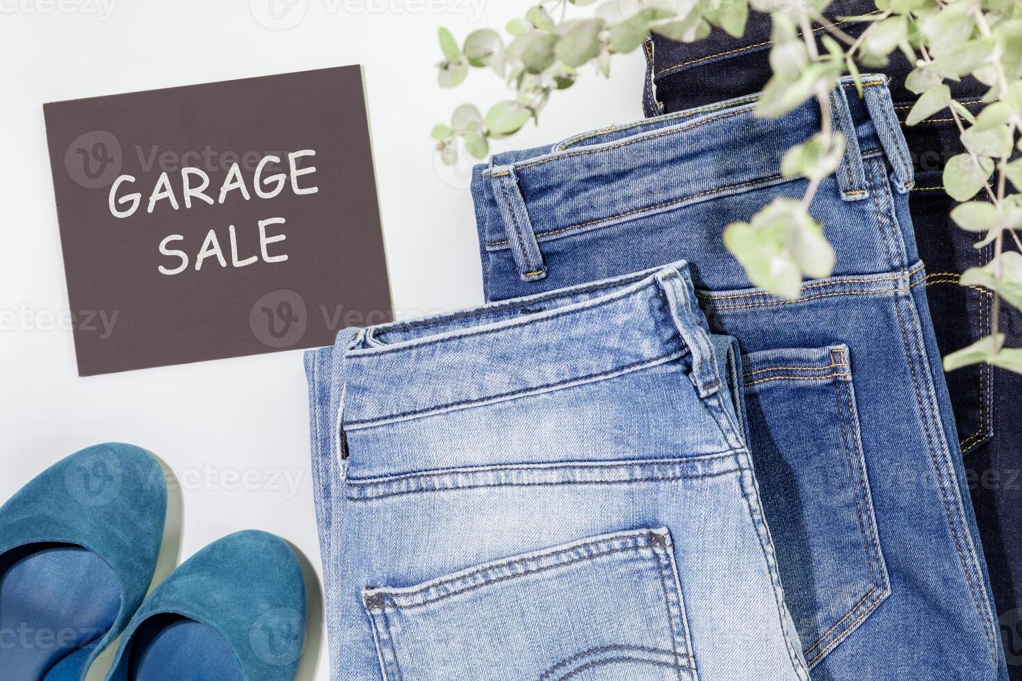 Second hande clothes and chalkboard with inscription Garage Sale photo