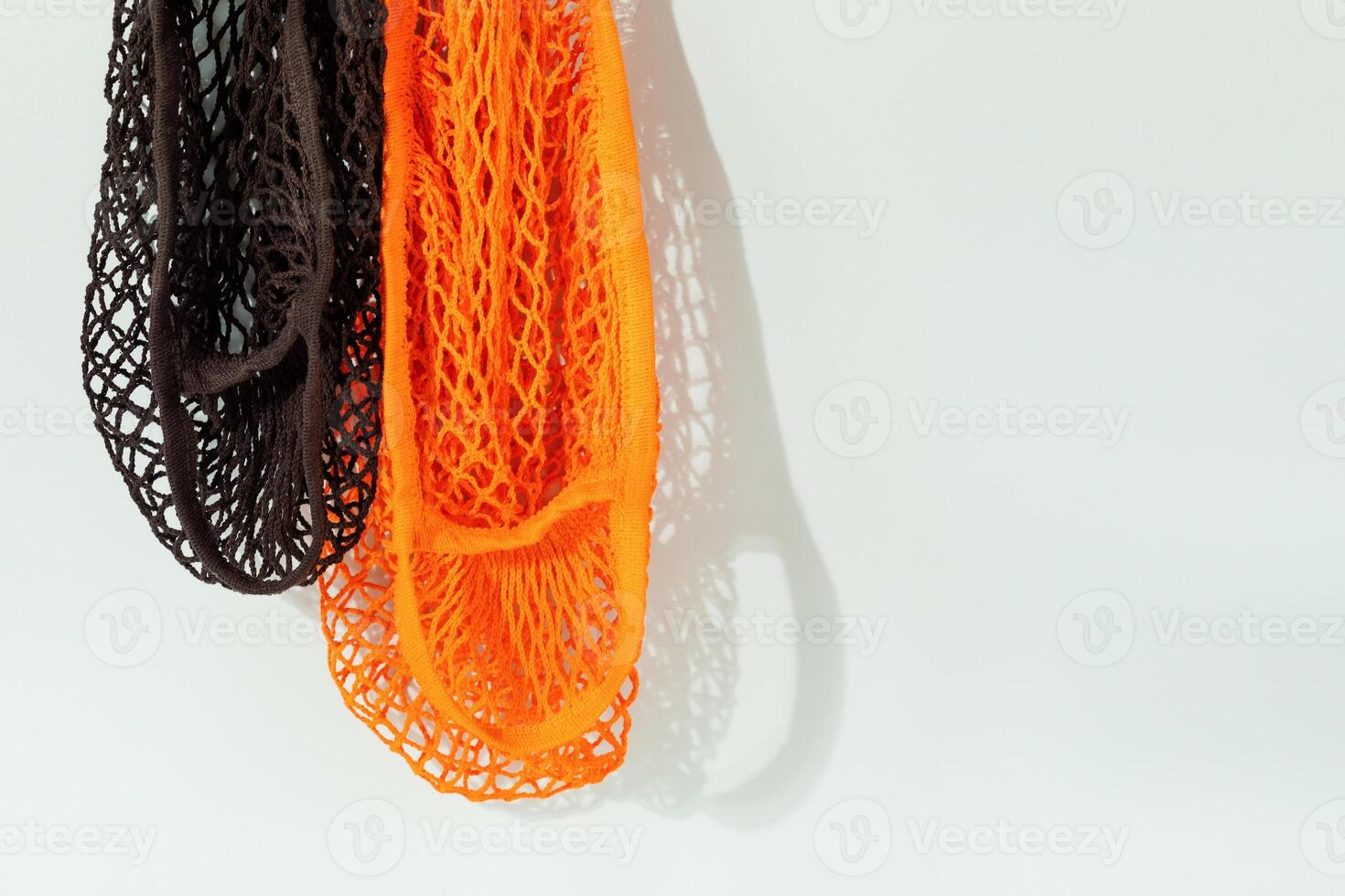 Natural mesh eco bags on blue background with copy space photo