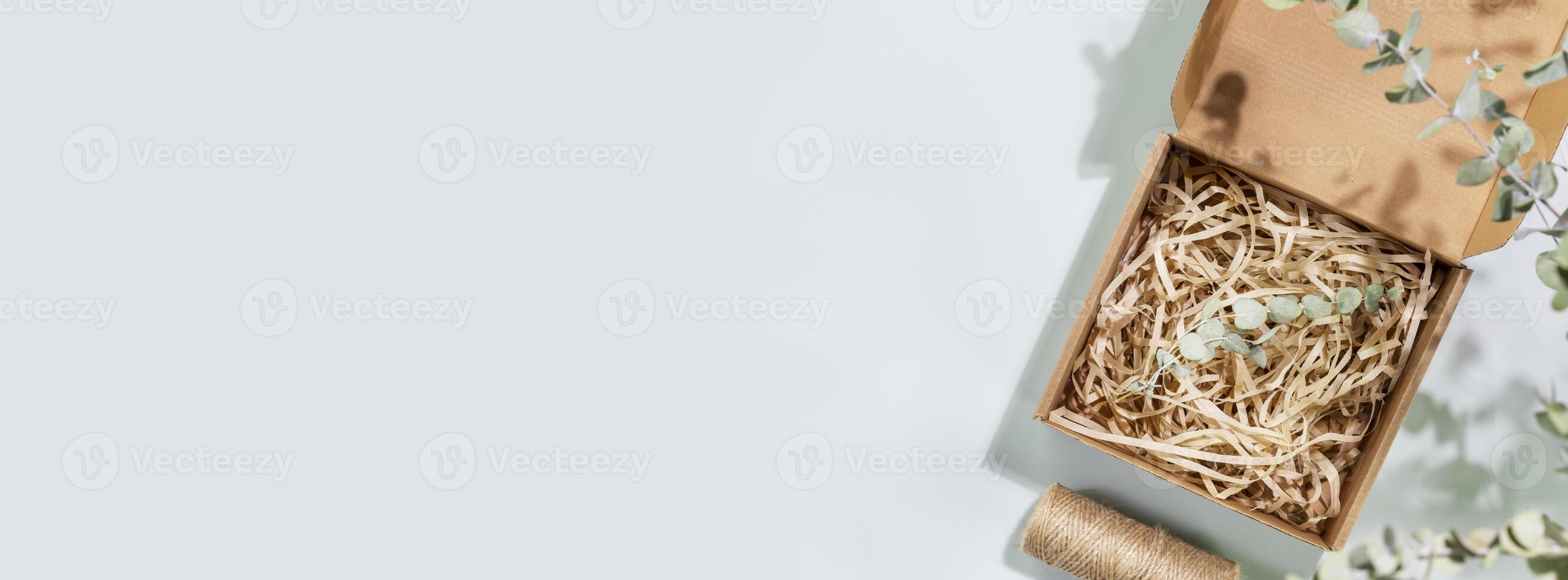 Eco friendly shopping banner with cardboard box with shredded paper photo