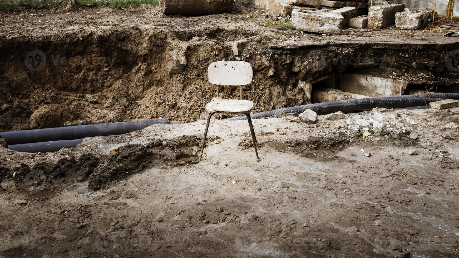 Empty old chair against the background of a break in the scorched earth photo