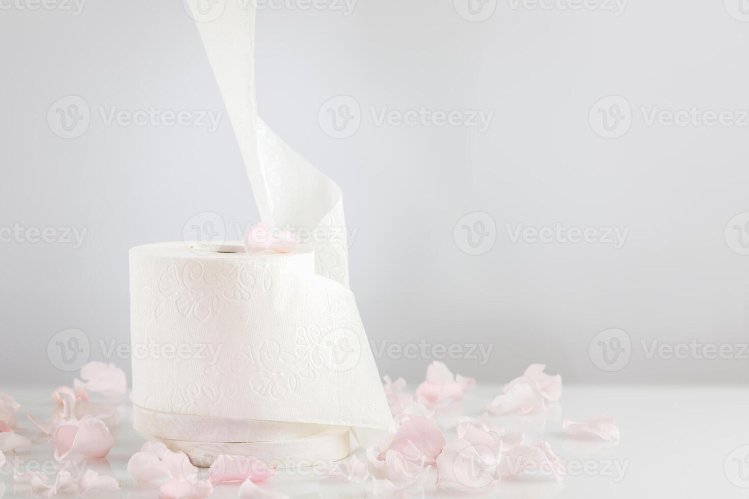 Roll of natural white toilet paper on a light background with copy space photo