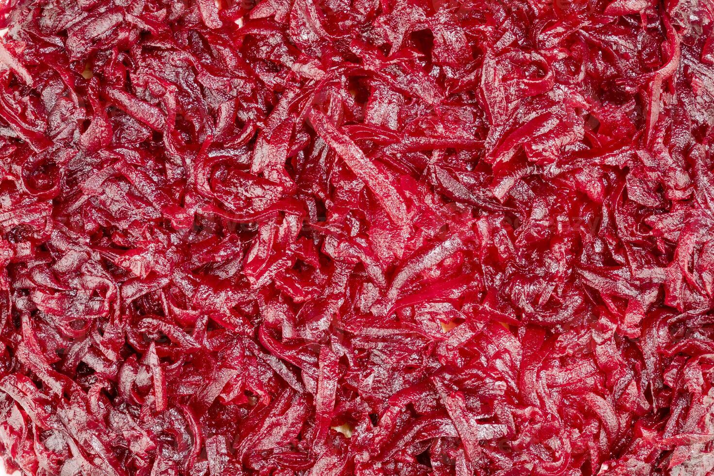 Vegetable background with close up of boiled grated beets photo