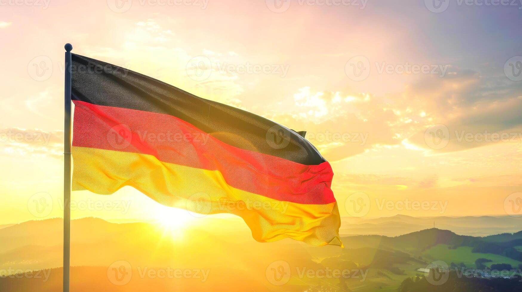 German flag waving against backdrop of beautiful sunset photo