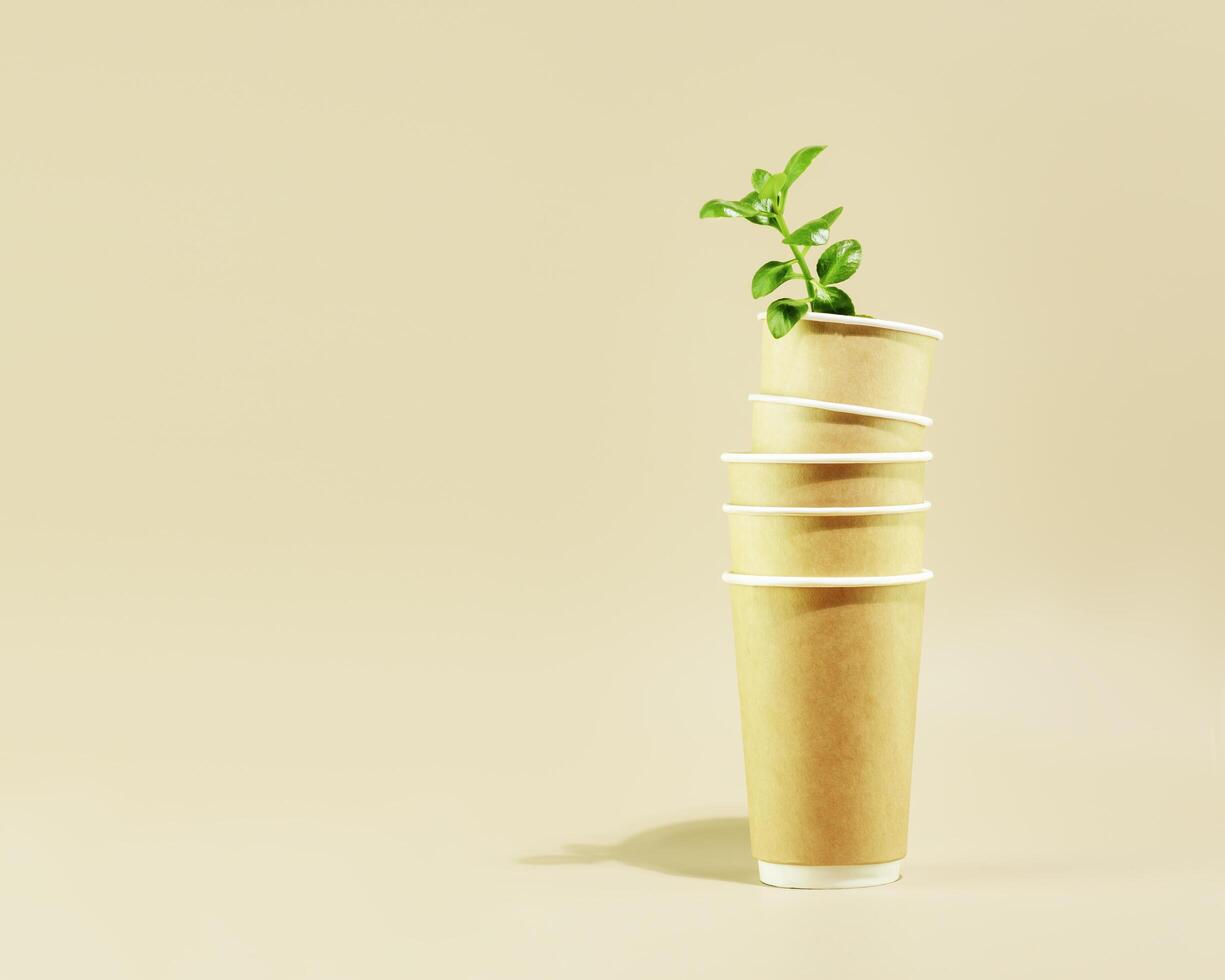 Green shoot in disposable eco friendly cardboard cups and copy space photo
