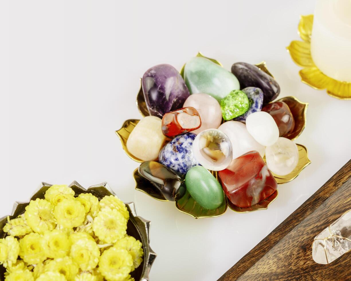 Crystals gemstones set, candle and dry flowers on white background photo