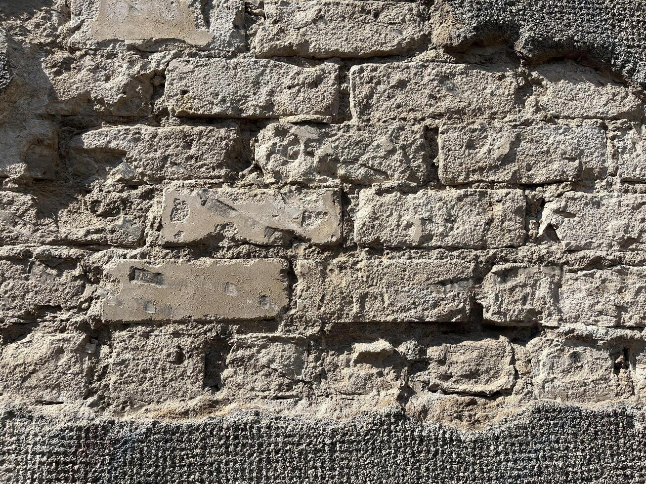 Old grey brick wall. ancient wall. Masonry texture, stonework pattern background for wallpaper or graphic design photo