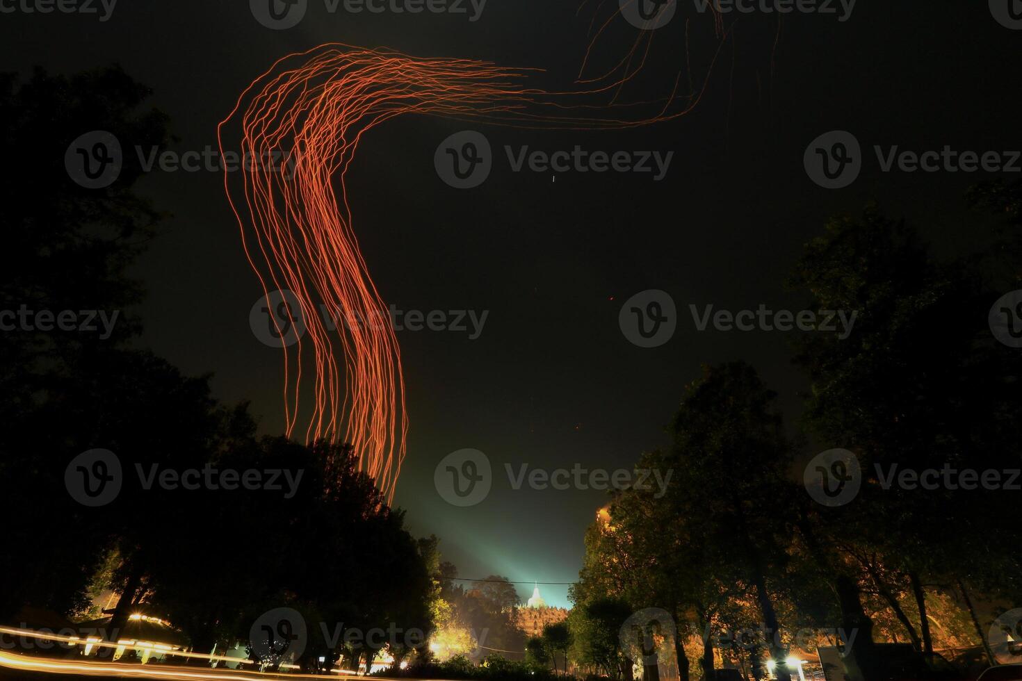 A Red Light Streaks In The Sky On Borobudur Temple photo