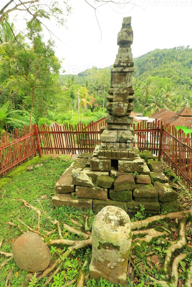 A Stone Wall With A Fence And A Stone Wall With A Fence Around It photo