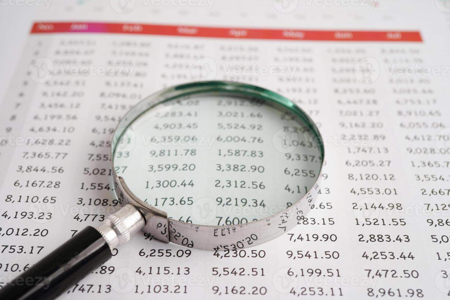 Magnifying glass on charts graphs paper. Financial development, Banking Account, Statistics, Investment Analytic research data economy. photo
