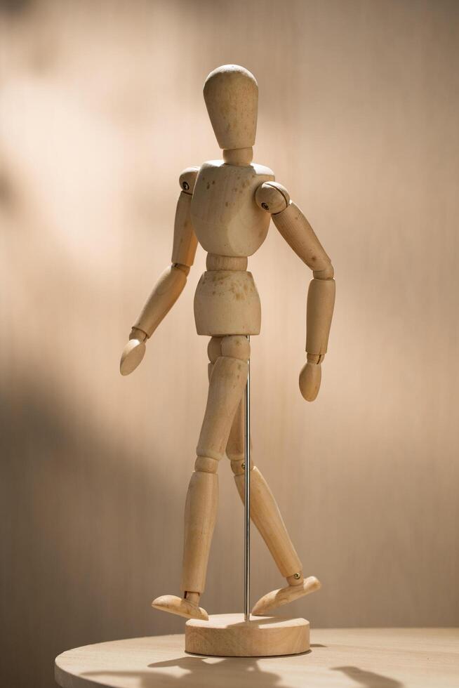 An artist wooden mannequin stands poised, ready to inspire creators with its lifelike articulation and elegant design. photo
