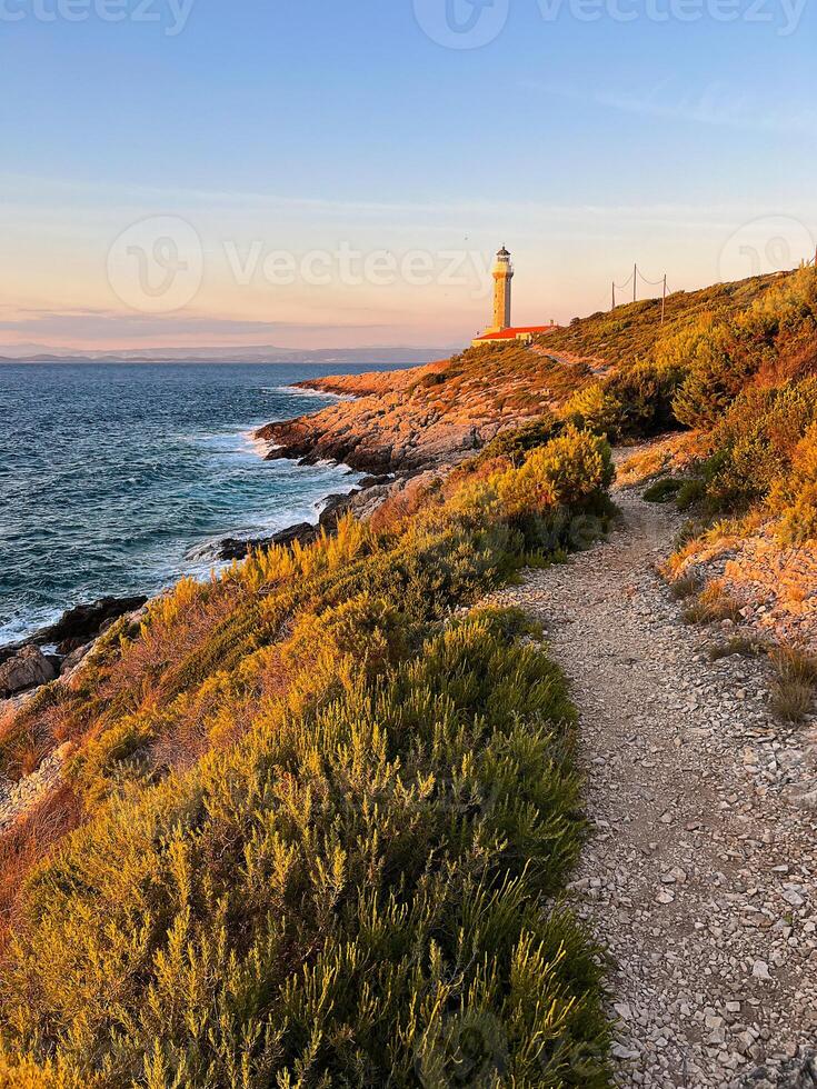 Lighthouse Stoncica at sunset light on island Vis, Croatia. photo