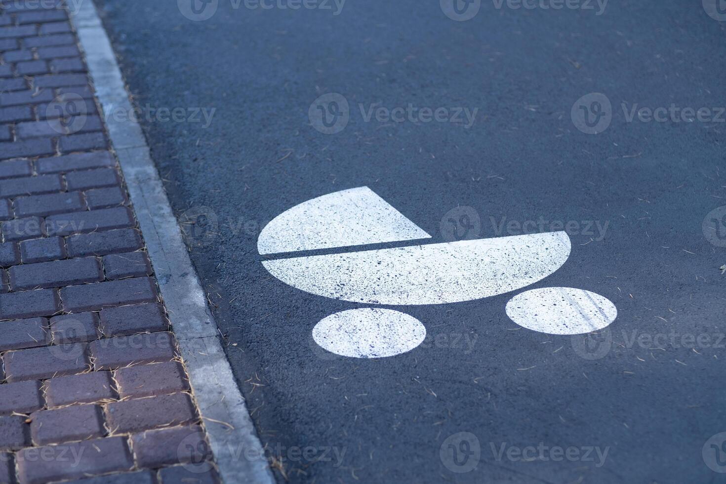 A sign for a stroller for children drawn on the asphalt in a city park photo