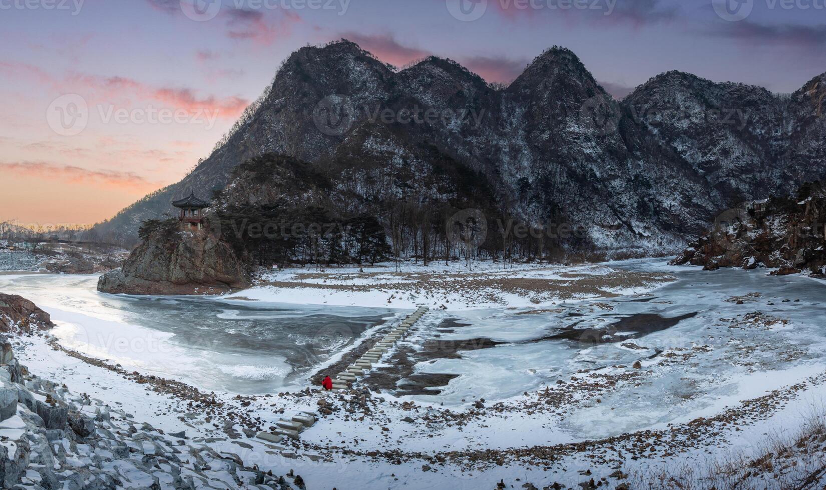 Snow capped mountains and frozen rivers on a clear day in winter in sunset, South Korea. photo