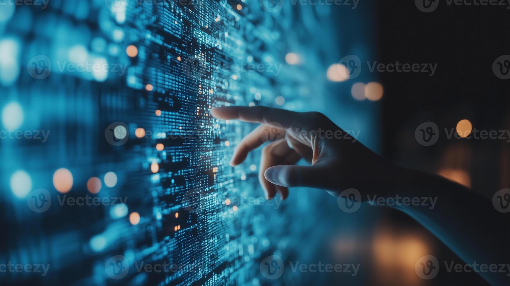 A hand reaches out to interact with a glowing digital interface displaying intricate data patterns in a darkened room photo