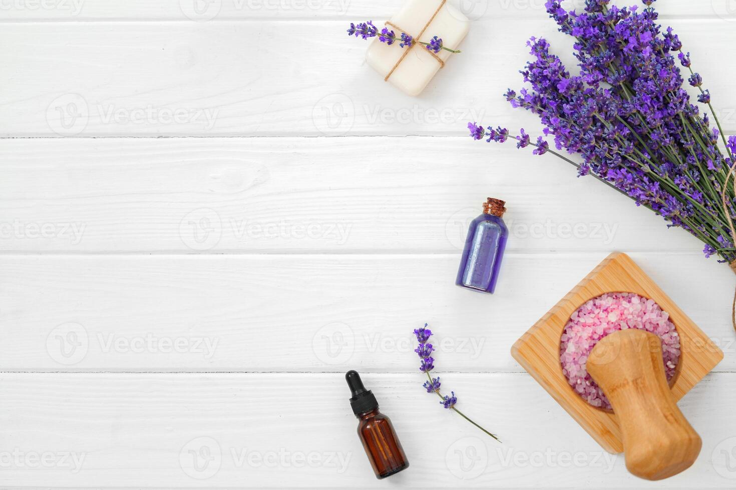 Lavender soap bars and spa products with lavender flowers on a white wooden table photo