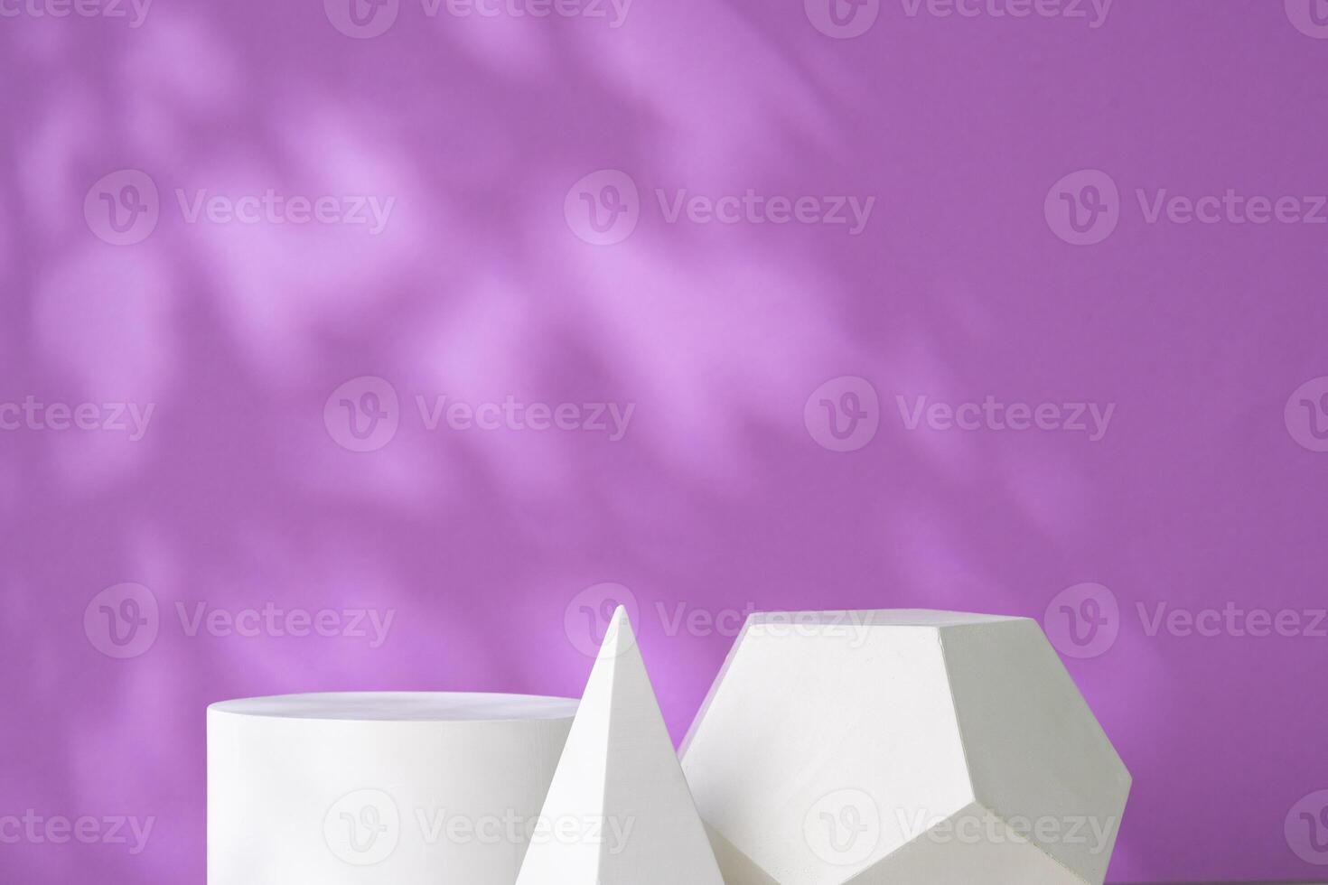 White geometric shapes against a soft purple background with gentle shadows photo