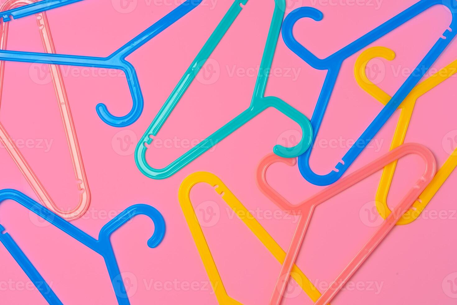 Flat lay composition with empty hangers on pink background photo