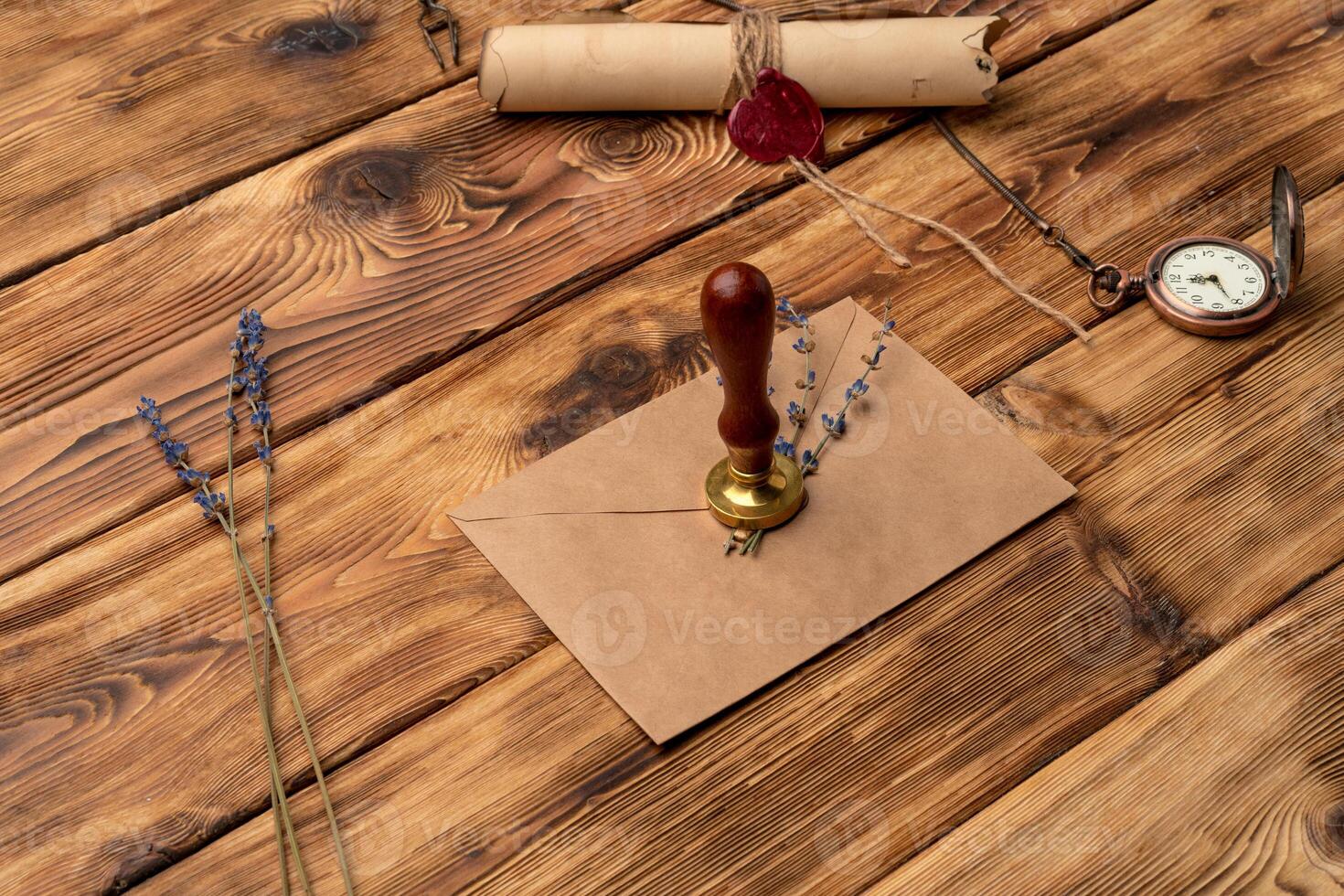 Envelope with wax seal stamp on wooden background, flat lay photo