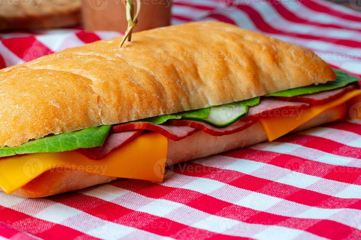 Ham sandwich with cheese and lettuce on table photo