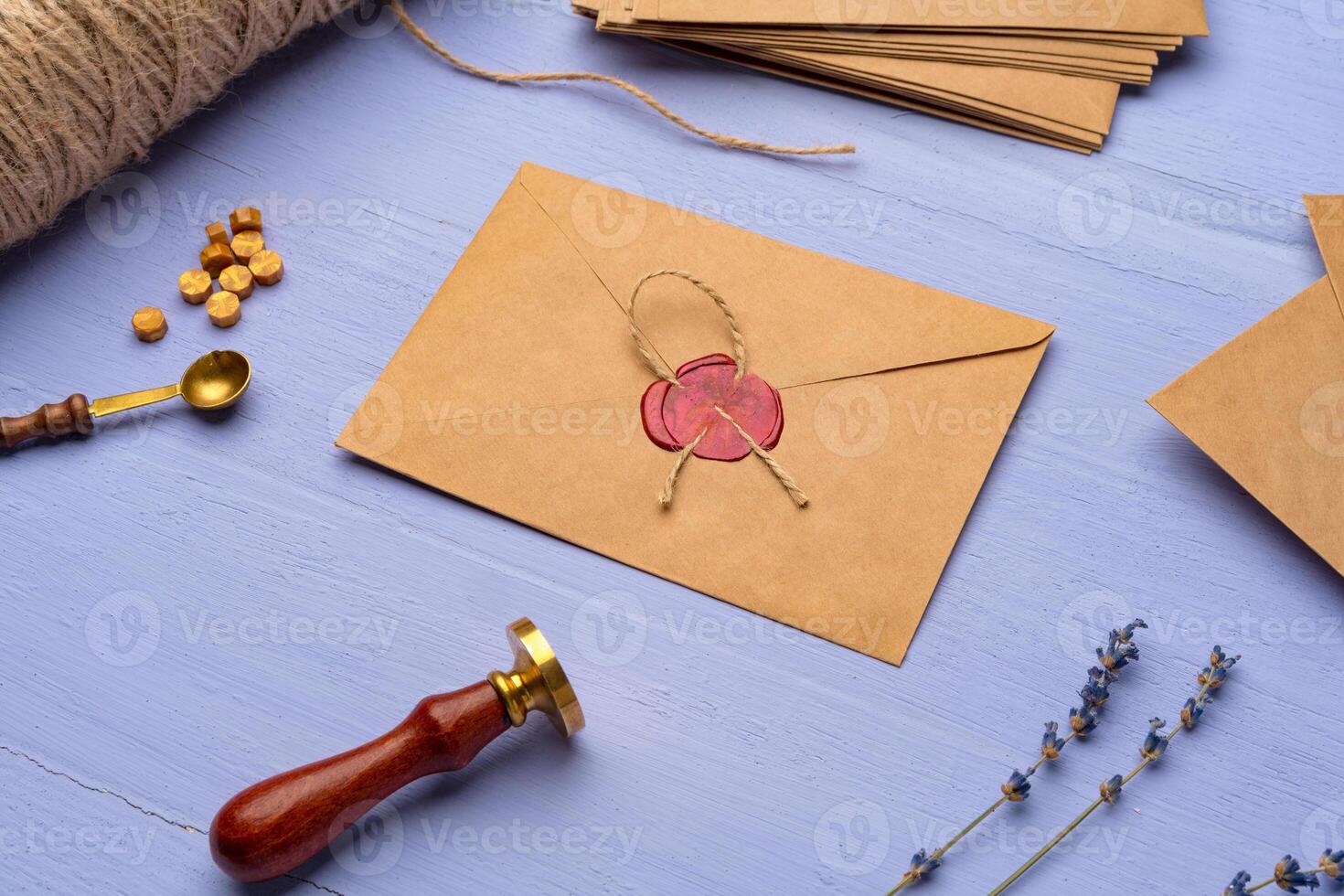 Handmade paper envelope on lavender wooden table photo