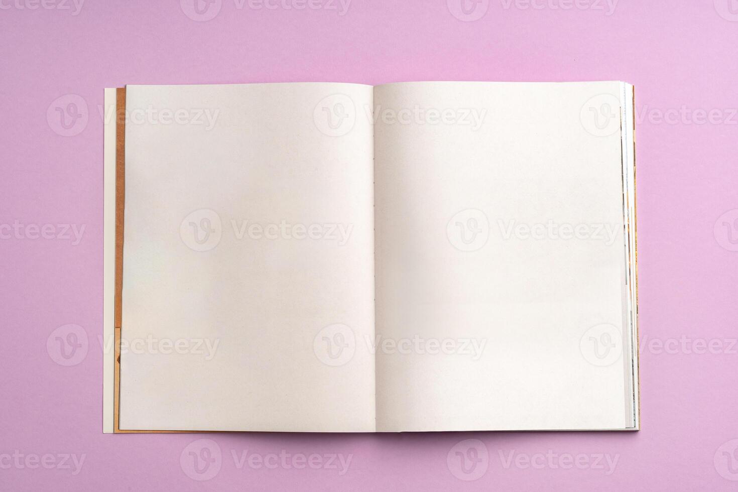 view of notebook with blank pages on a pink background photo