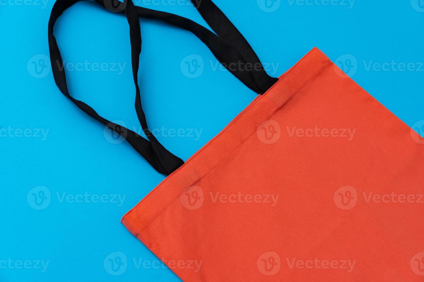 Textile shopping bag on blue paper background flat lay photo