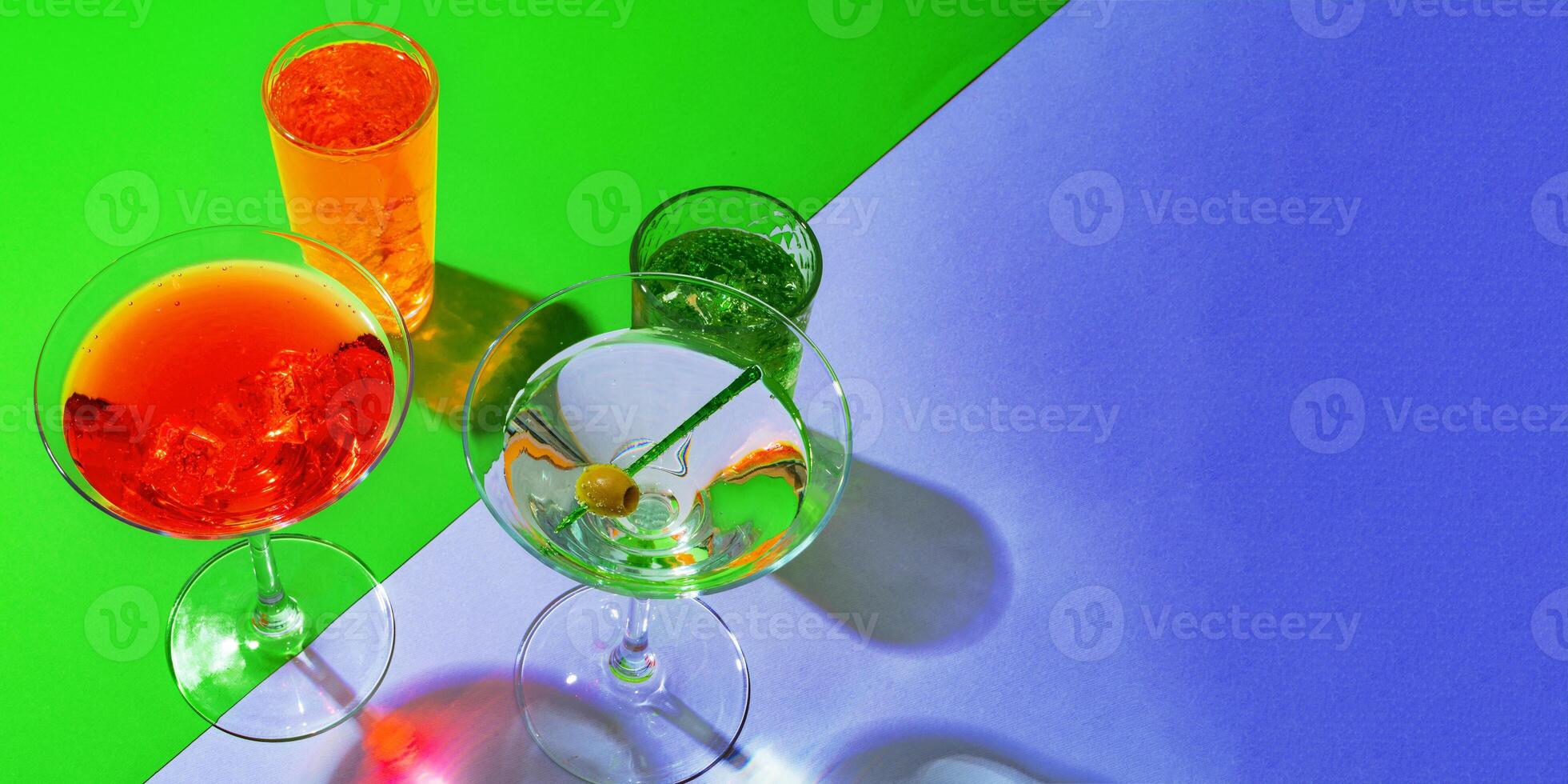 Cold and refreshing cocktails on color background photo