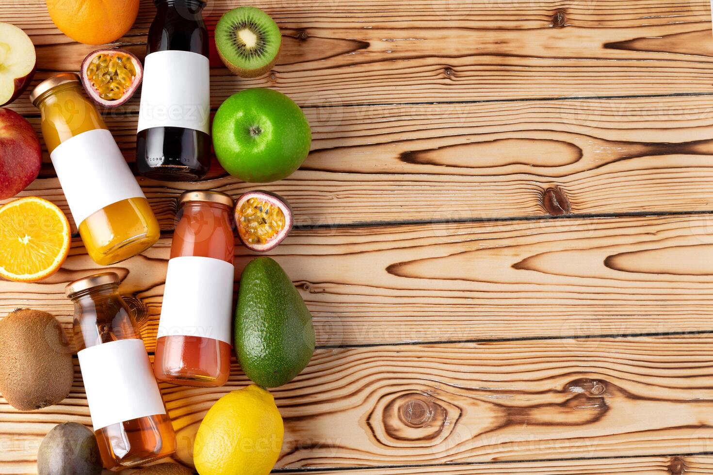 Fruits and freshly squeezed fruits juice on wooden table photo