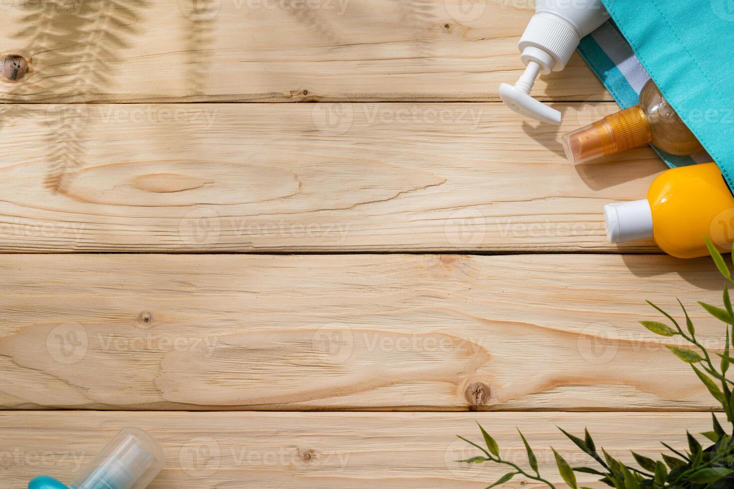 Sunscreen cream bottles in beach bag on wooden background photo