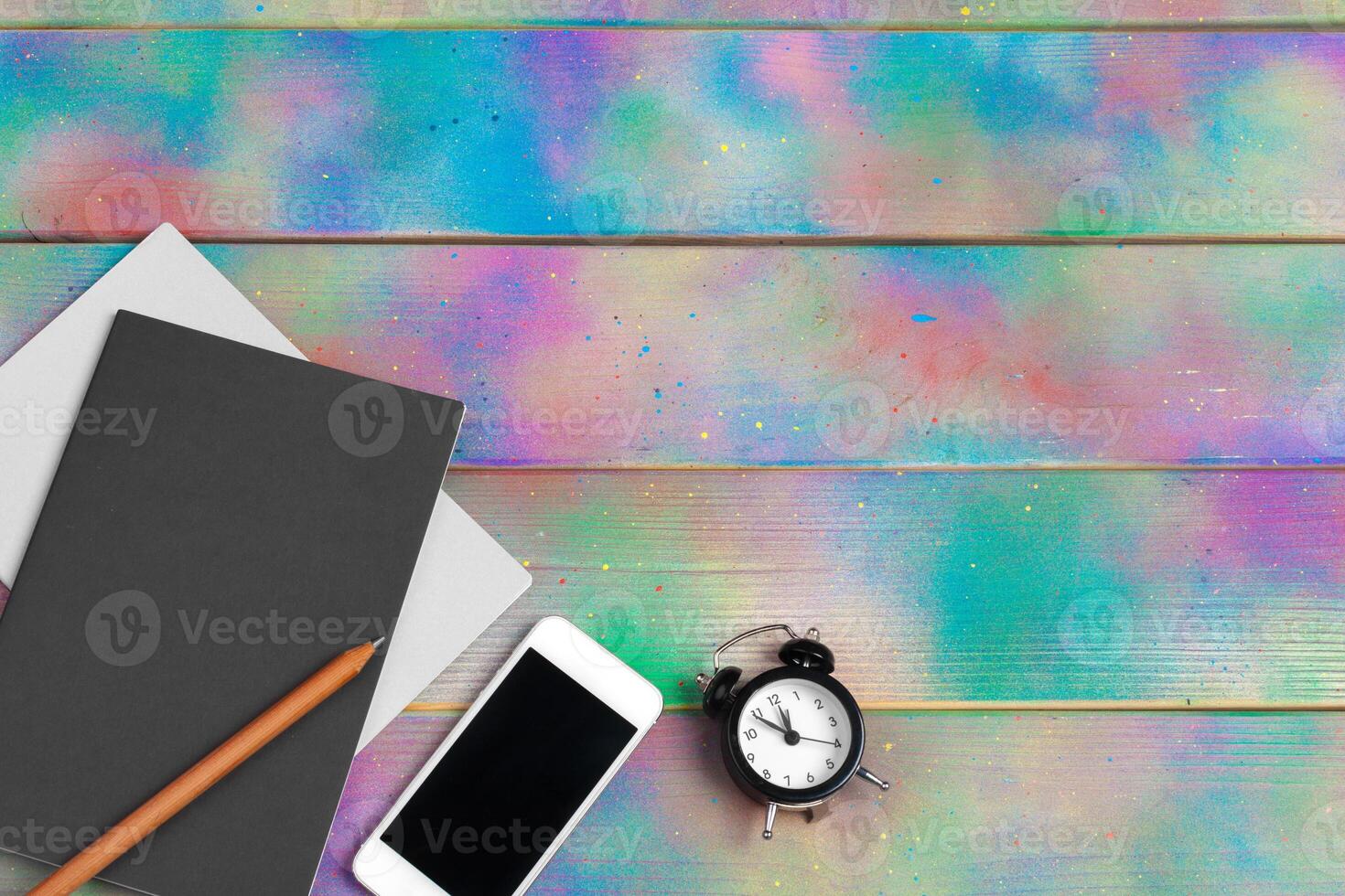 smartphone, tablet, notebook pen on the background of a wooden table photo