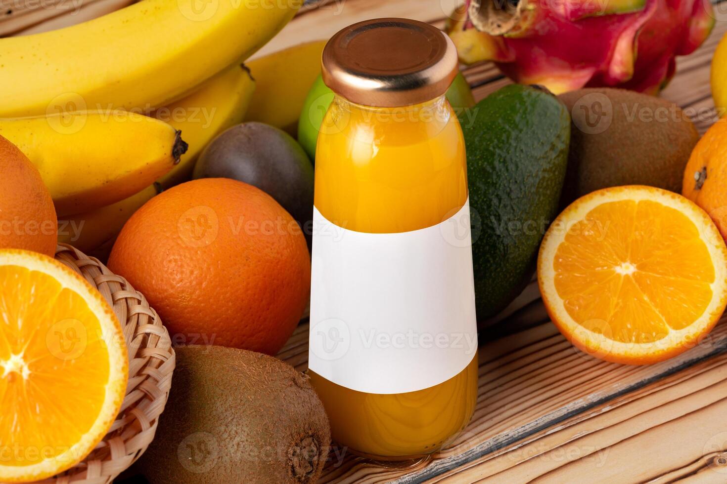 Fruit drink in glass bottle and frsh fruits on wooden background photo