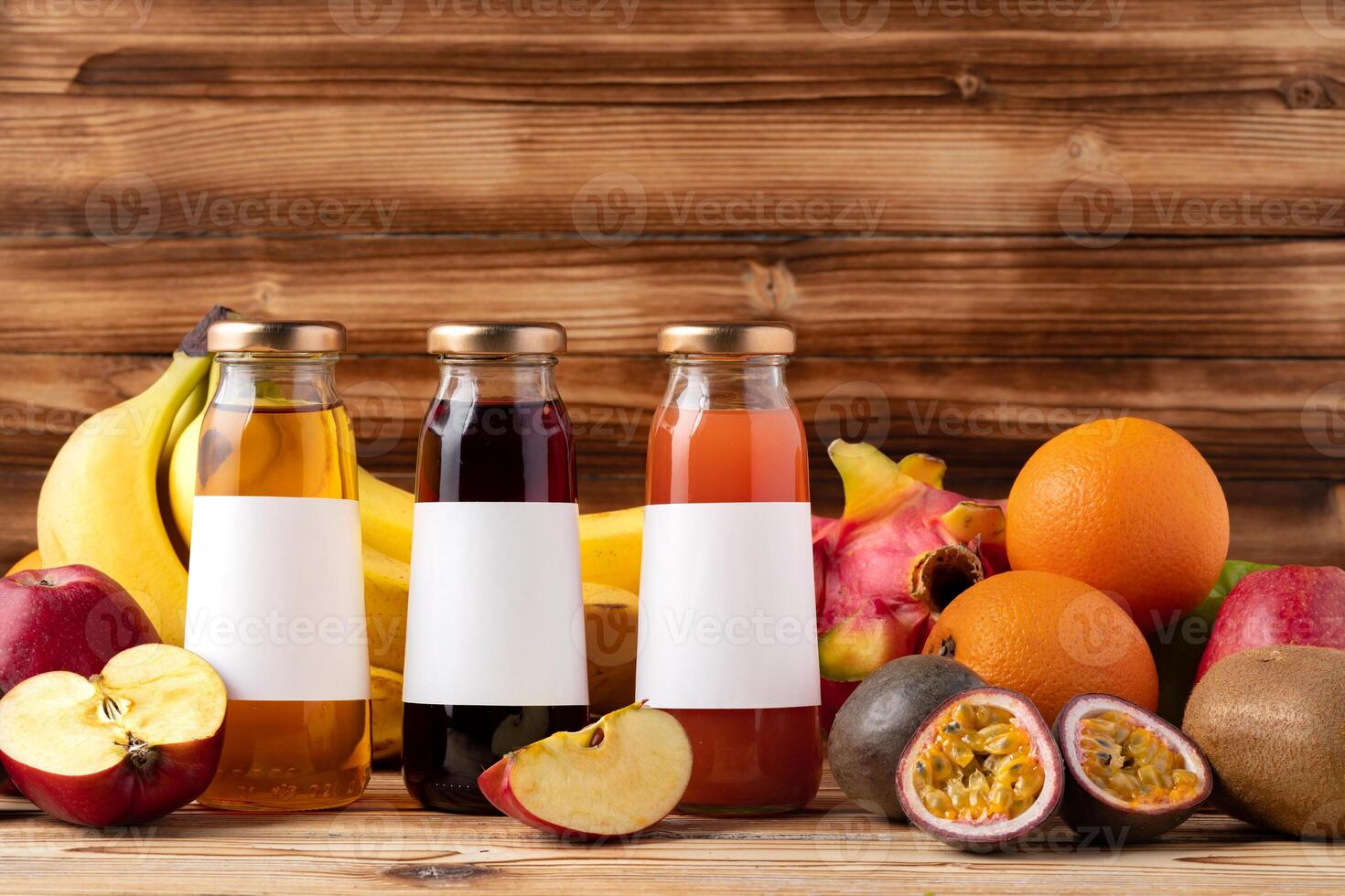 Fruit drink in glass bottle and frsh fruits on wooden background photo