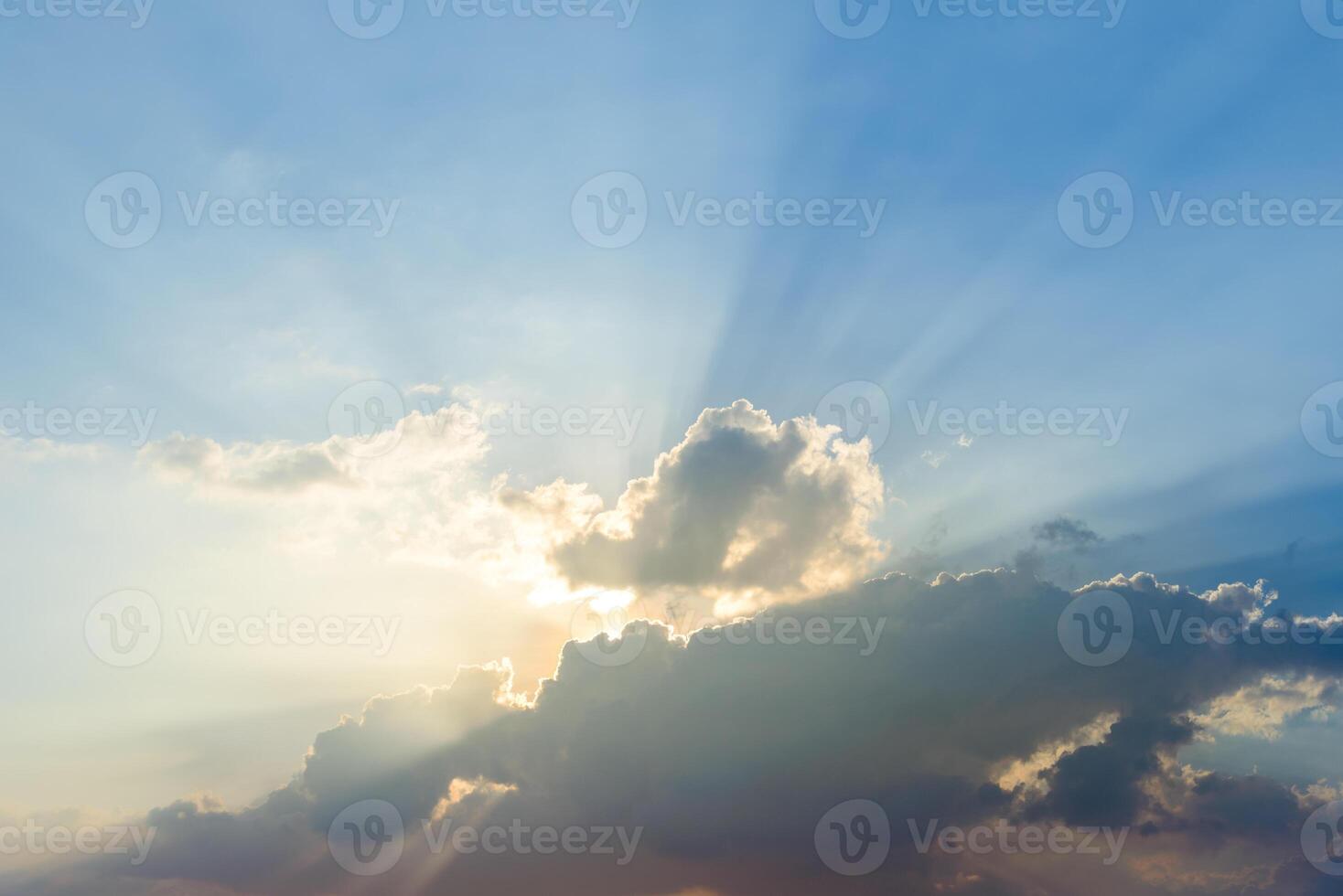 Beautiful dramatic sky clouds with light rays at sunset. Natural landscape for background photo