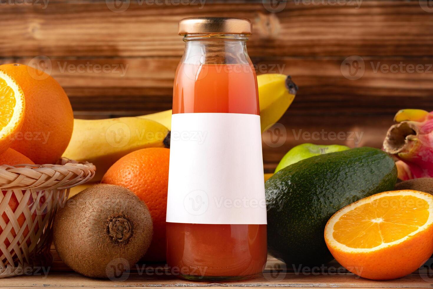 Fruit drink in glass bottle and frsh fruits on wooden background photo
