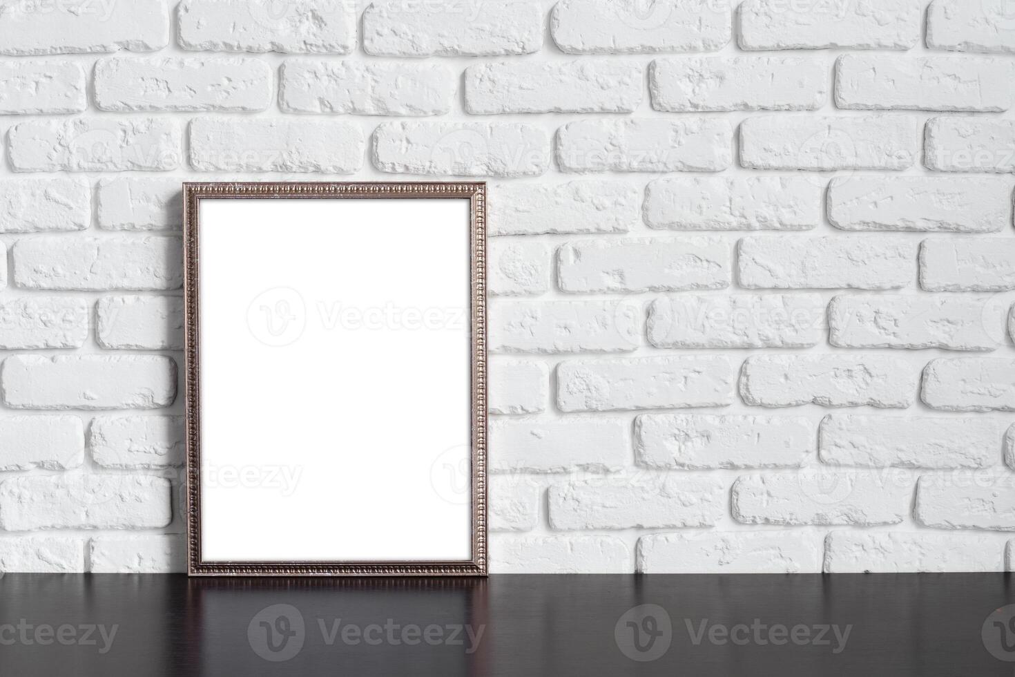 Blank picture frame against brick wall with copy space photo