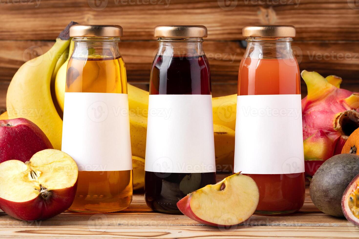 Fruit drink in glass bottle and frsh fruits on wooden background photo