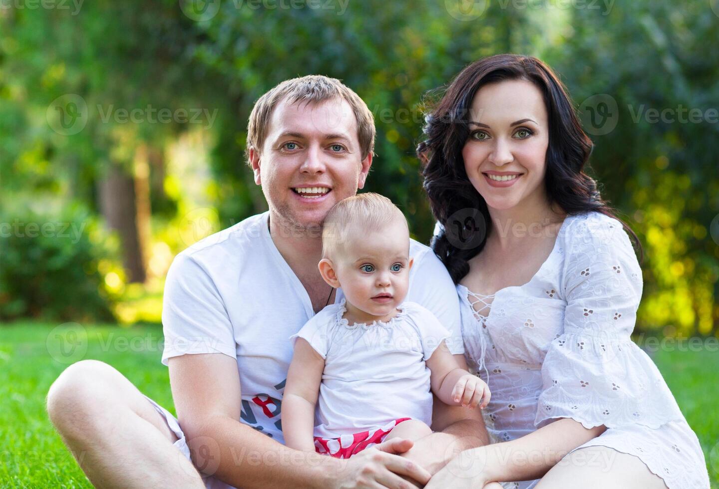 Happy young family with baby girl photo