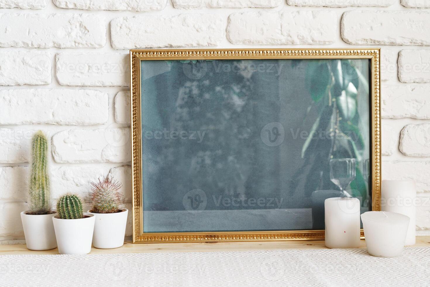 Square wooden photo frame and cactus plants on the table