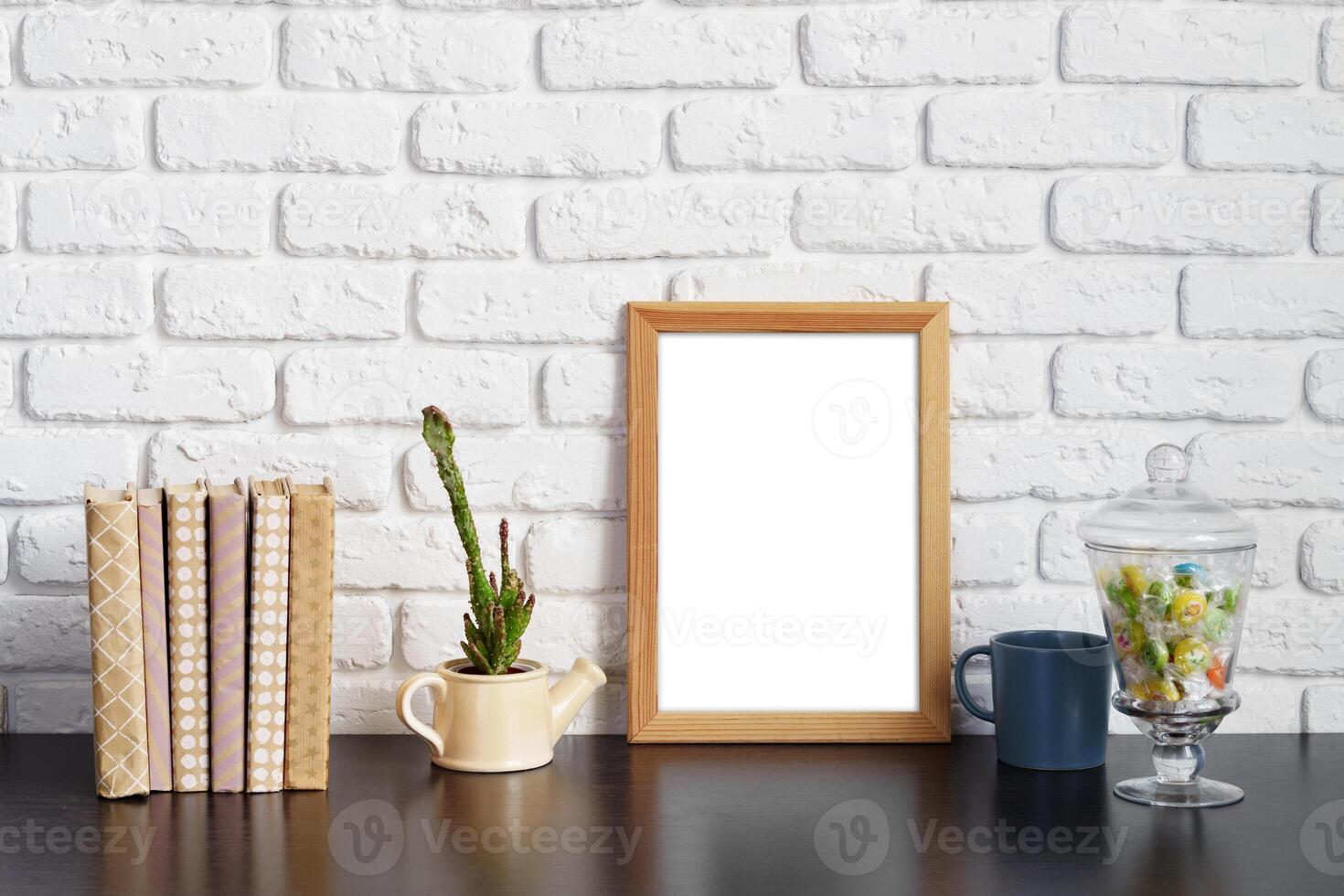 Books with picture frame on wooden table photo