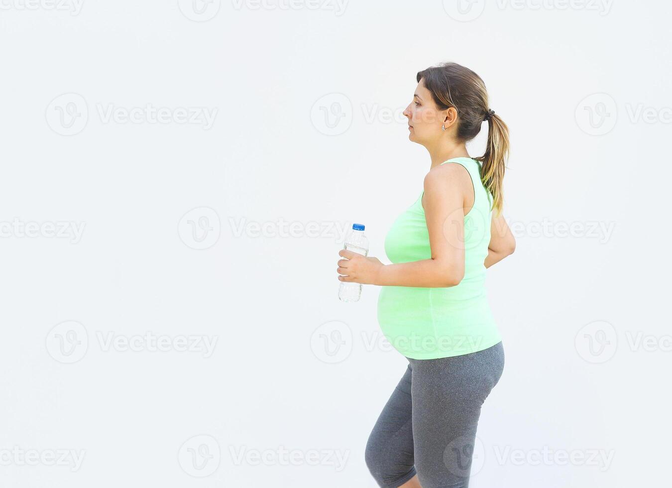 Pregnant woman doing fitness exercises photo