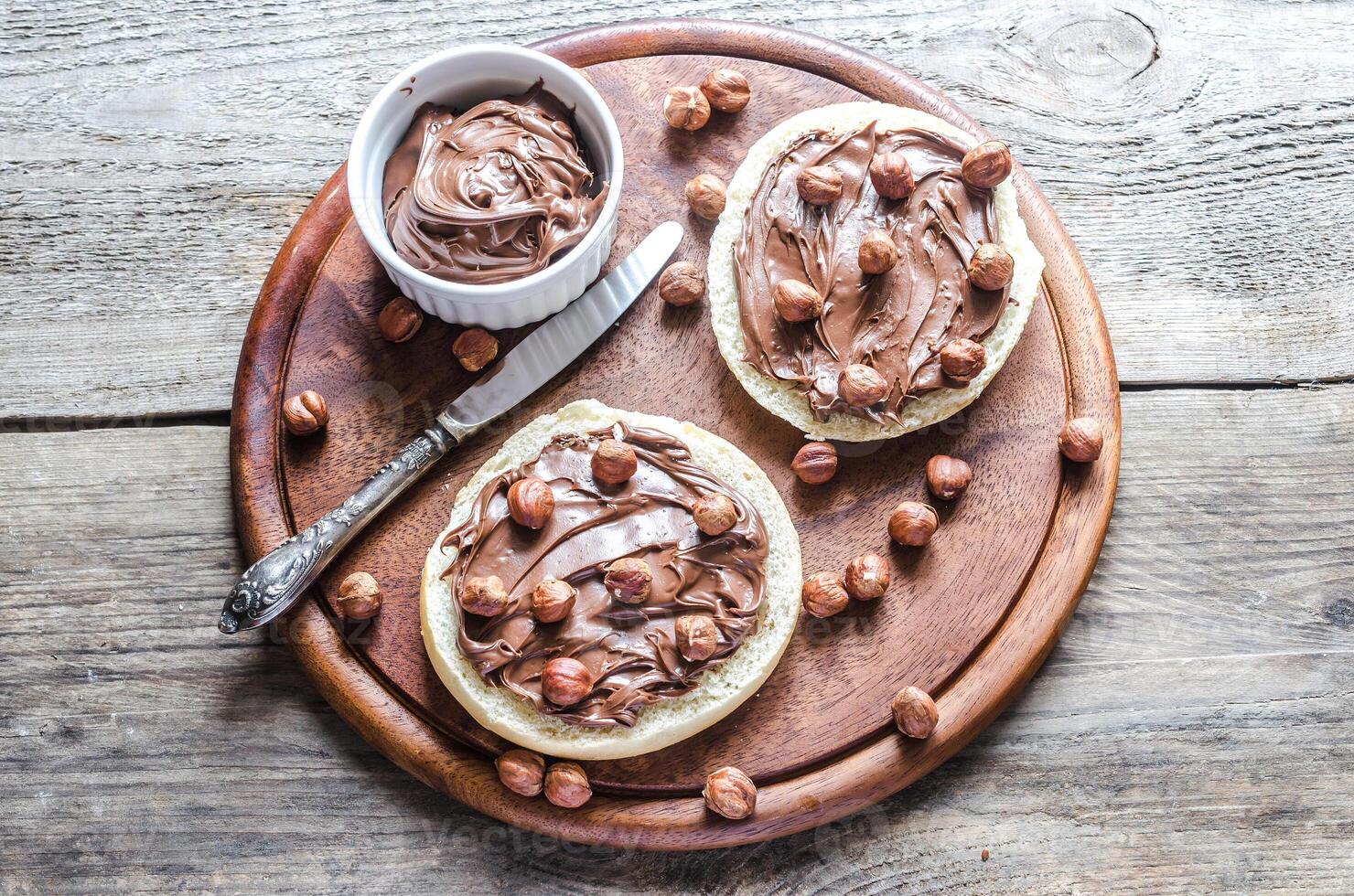 Bun slices with chocolate cream and nuts photo